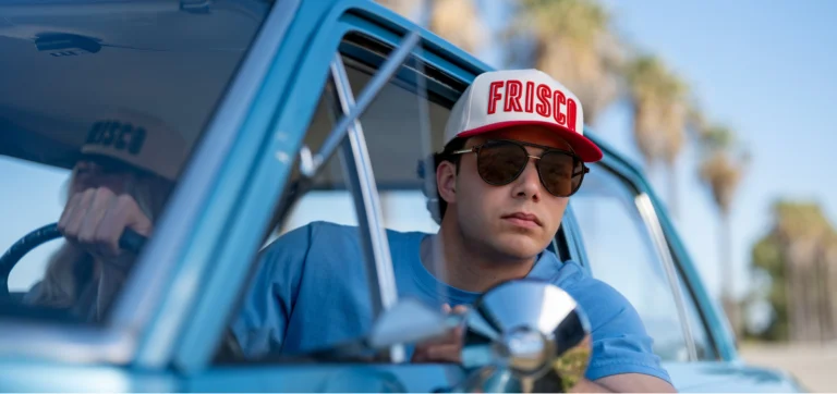Cap America man in car with embroidered ball cap and sunglasses