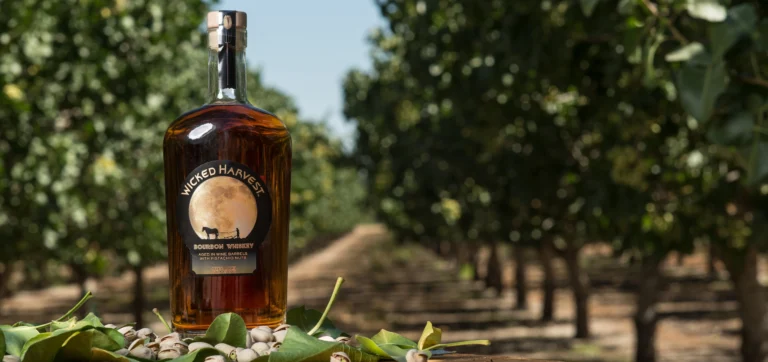 Wicked Harvest Spirits bottle of bourbon in a field of pistachios